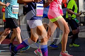 Marathon running race, women runners feet on road