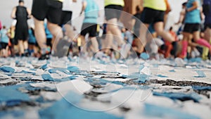 Marathon start finish line with confetti runners