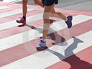 Marathoners run very fast over the pedestrian crossing in the ci