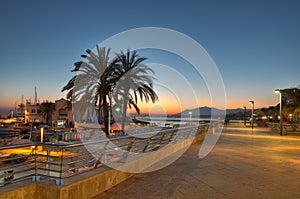 Marbella harbor and cliff at sunset photo