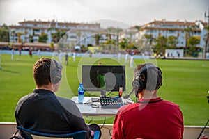 Marbella - January 17, 2020: commentators on football game watching match. stream for television and radio.