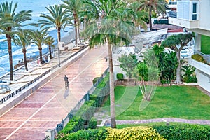 Marbella, Spain - April 6, 2023: City promenade along the ocean at dawn