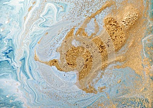 Marble abstract acrylic background. Blue marbling artwork texture. Golden glitter.