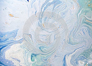 Marble abstract acrylic background. Blue marbling artwork texture. Golden glitter.