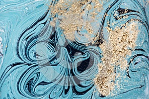 Marble abstract acrylic background. Blue marbling artwork texture. Golden glitter.