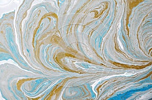 Marble abstract acrylic background. Blue marbling artwork texture. Golden glitter. Design, pale.