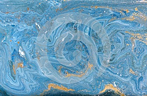 Marble abstract acrylic background. Nature blue marbling artwork texture. Golden glitter.