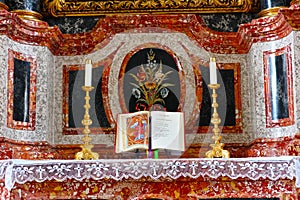 Marble altar with holy bible and candlesticks at Christmas