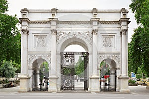 Marble Arch with green tree branches in London