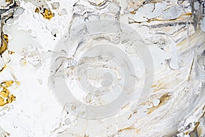 Marble background texture with gold, black, grey and white colors, using acrylic pouring medium art technique. Useful as a photo