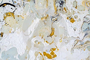 Marble background texture with gold, black, turqoise, blue and white colors, using acrylic pouring medium art technique. Useful as