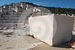 Marble block on foreground and quarry at background