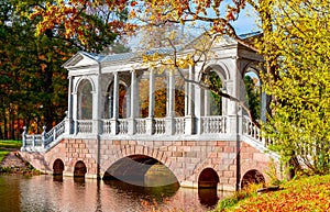 Marble bridge in autumn foliage in Catherine park, Pushkin (Tsarskoe Selo), Saint Petersburg, Russia