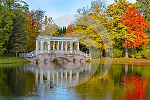 Marble bridge in mellow autumn golden fall in Catherine park, Pushkin, St. Petersburg, Russia