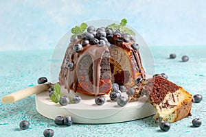 Marble bundt cake with chocolate icing and blueberries