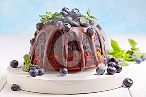 Marble bundt cake with chocolate icing and blueberries