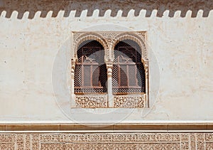 Marble capitals and stucco decoration on two windows in Patio del Cuarto Dorado in Mexuar in Comares Palace Alhambra, Andalusia,