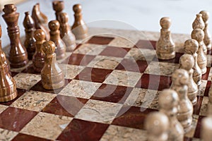 Marble chess board with two pawns opposing each other