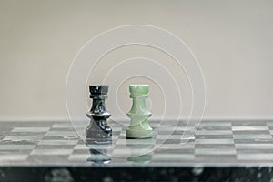 Marble chess pieces, on a marble chessboard. Closeup