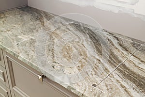 marble countertop with prepared incision for cooktop hob during renovation in modern kitchen
