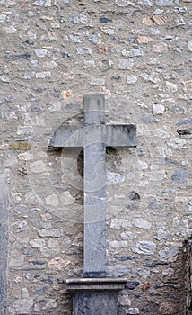 Marble cross on wall background