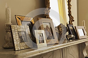 Marble Fireplace Mantel With Framed Pictures And Mirror