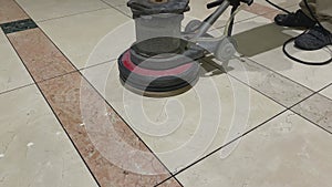 Marble floor polishing with a professional scrubber in office building lobby