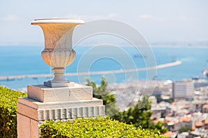 Marble flowerpot on a background of palm and sky