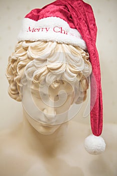 A Marble Greek Statue With Santa Hat