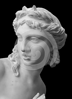 Marble head sculpture of young woman, ancient Greek goddess art bust statue isolated on black background photo