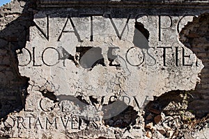 Marble inscription on a Roman ruin in ancient Ostia. Example of