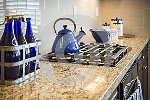 Marble Kitchen Counter and Stove With Cobalt Blue Decor photo