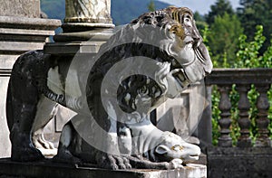 Marble lion - ancient sculpture in the park of Peles Castle, Sinaia, Romania