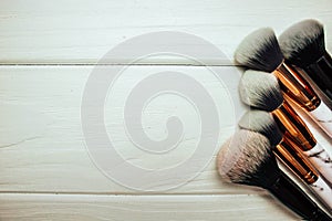 Marble makeup brushes on wood white background in winter