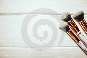 Marble makeup brushes on wood white background in winter