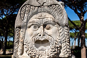 Marble Mask decoration in Ostia Antica theatre. Ancient Rome 1st century mask in the proscenium of Ostia antica, part