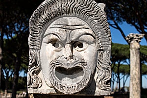 Marble Mask decoration in Ostia Antica theatre. Ancient Rome 1st century mask in the proscenium of Ostia antica, part
