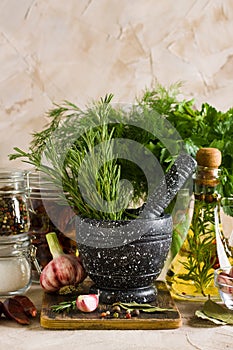 Marble mortar and pestles with herbs garlic and pepper