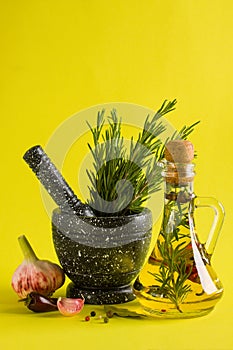 Marble mortar and pestles with rosemary garlic and pepper