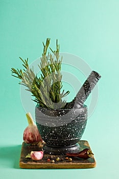 Marble mortar and pestles with rosemary garlic and pepper