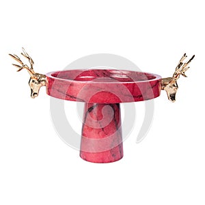 Marble-patterned cake stand with gold deer head detail isolated on a white background
