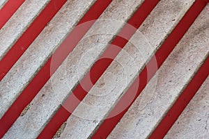 Marble and red steps of staircase at oblique angle