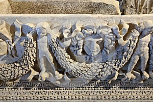 Marble sarcophagus with a bas-relief of a woman\'s head and cherubs in the ancient city of Hierapolis, Pamukkale in Turkey photo