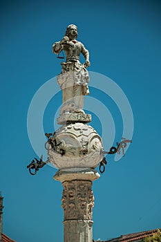 Marble sculpture representing justice on top of carved pillory