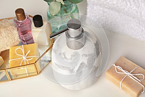 Marble soap dispenser and toiletries on white table