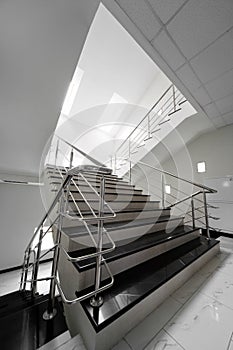 Marble staircase with a steel handrail