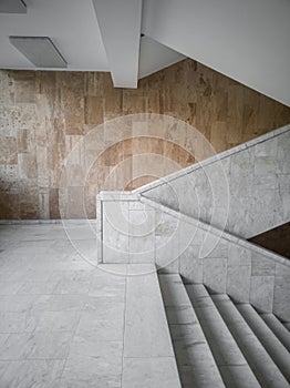 Marble stairs on the background of a marble-tiled wall side view