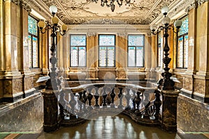 Marble stairs and corridor in the castle. Large vintage vintage retro hall decorated with marble. Luxury staircase made of marble