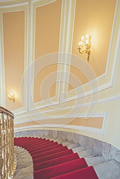 Marble stairs with red carpet
