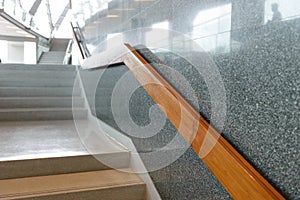 Marble stairs with wooden handrail in building for step up or down safety